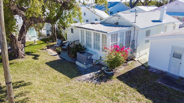 rear view of house with a residential view and a lawn