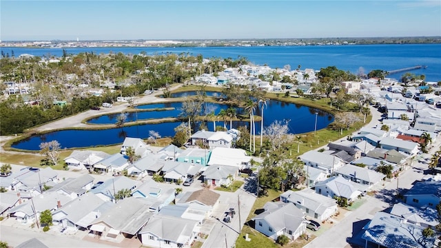 drone / aerial view with a residential view and a water view