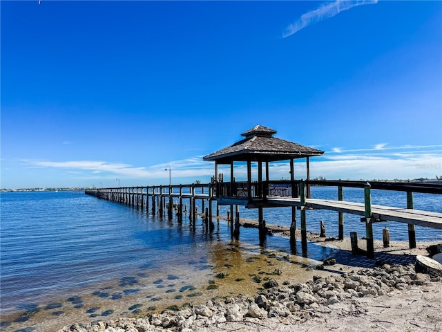 view of dock featuring a gazebo and a water view