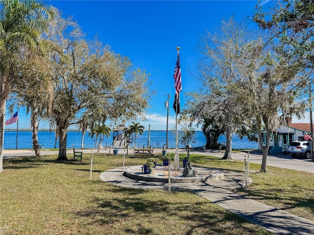 view of community featuring a yard and a water view