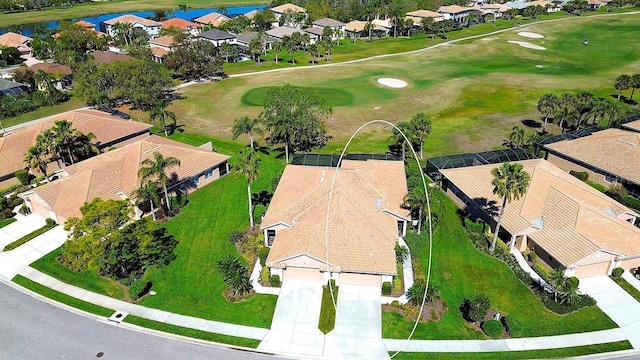 aerial view with a residential view, view of golf course, and a water view