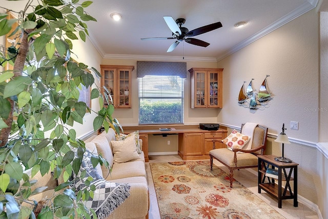 sitting room with crown molding, light tile patterned floors, a ceiling fan, and built in desk