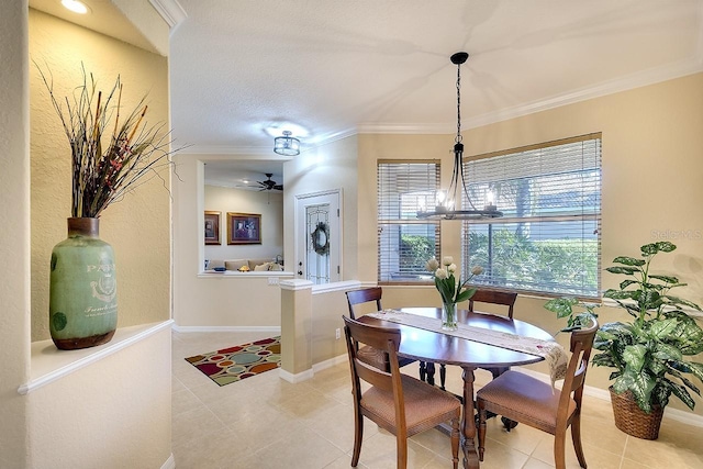 dining space featuring light tile patterned floors, baseboards, ornamental molding, and ceiling fan with notable chandelier