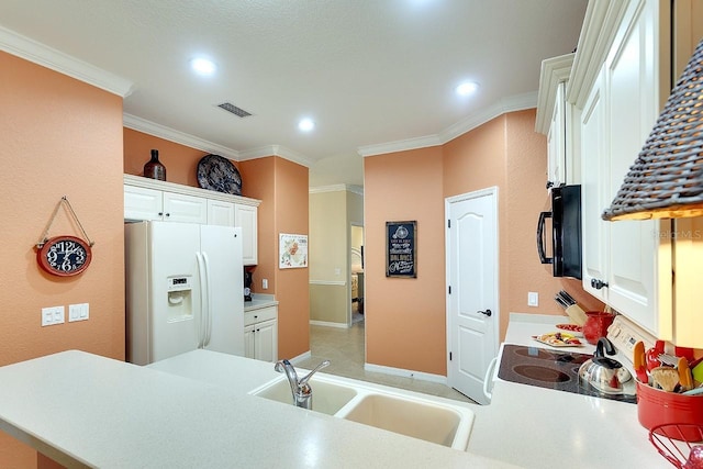 kitchen featuring crown molding, white refrigerator with ice dispenser, visible vents, and black microwave