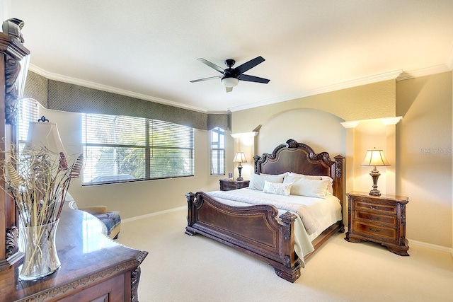 carpeted bedroom with ceiling fan, baseboards, and ornamental molding