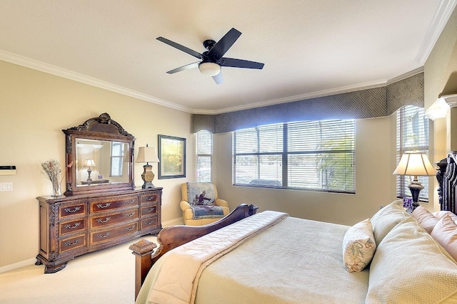 carpeted bedroom featuring crown molding, baseboards, and ceiling fan