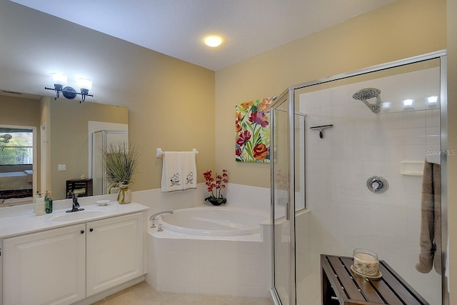 full bath with vanity, tile patterned floors, a bath, and a stall shower