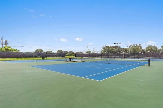 view of tennis court with fence