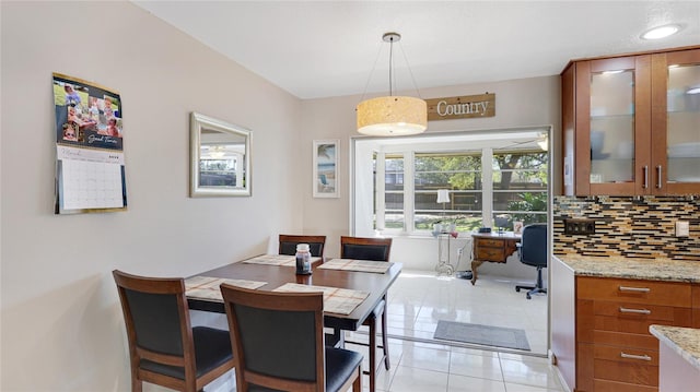 dining room featuring light tile patterned floors and a ceiling fan