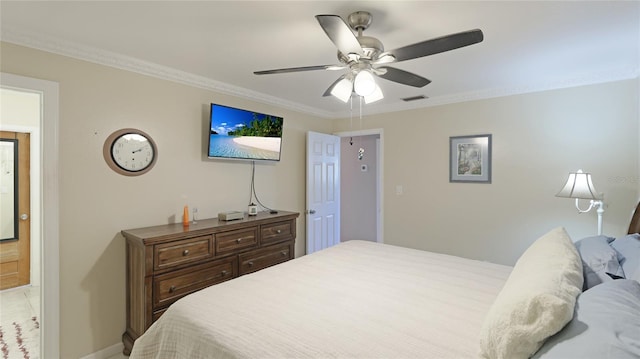 bedroom featuring ceiling fan, baseboards, visible vents, and crown molding