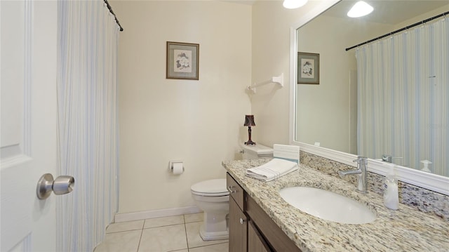 full bath featuring toilet, tile patterned flooring, baseboards, and vanity