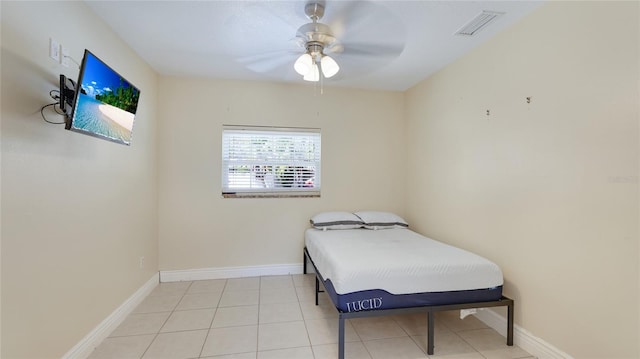 bedroom with a ceiling fan, tile patterned flooring, visible vents, and baseboards