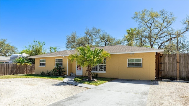 view of front of property featuring fence and stucco siding