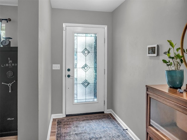 entryway with wood finished floors and baseboards