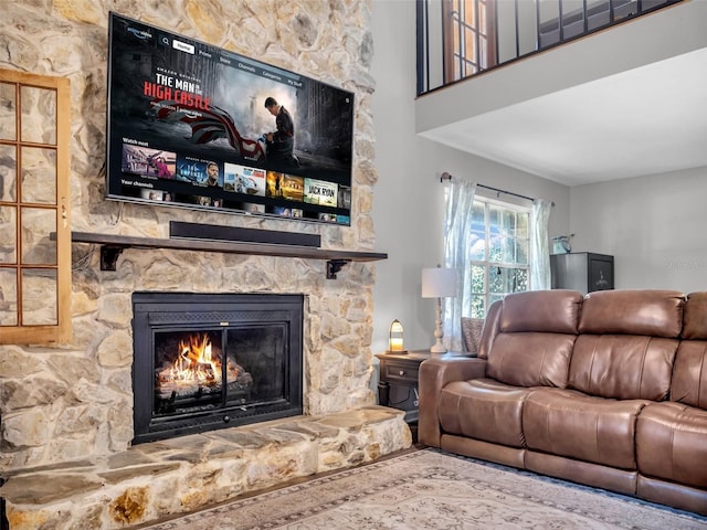 living area featuring a stone fireplace