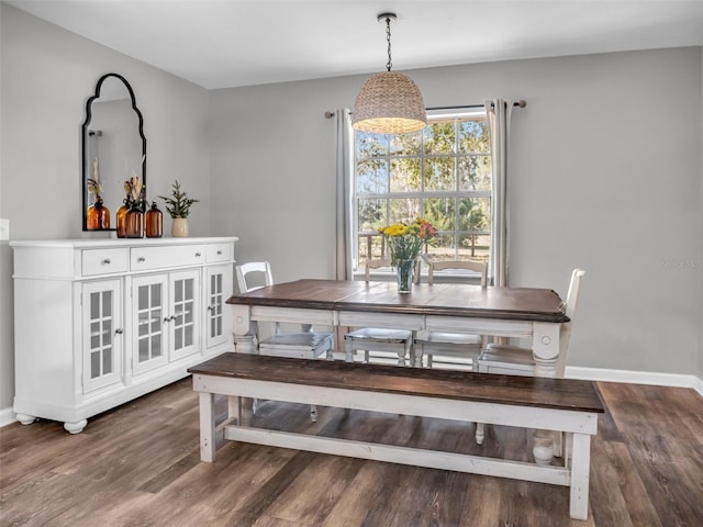 dining room featuring wood finished floors and baseboards