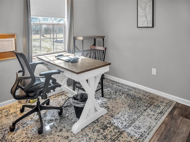 office space featuring wood finished floors and baseboards