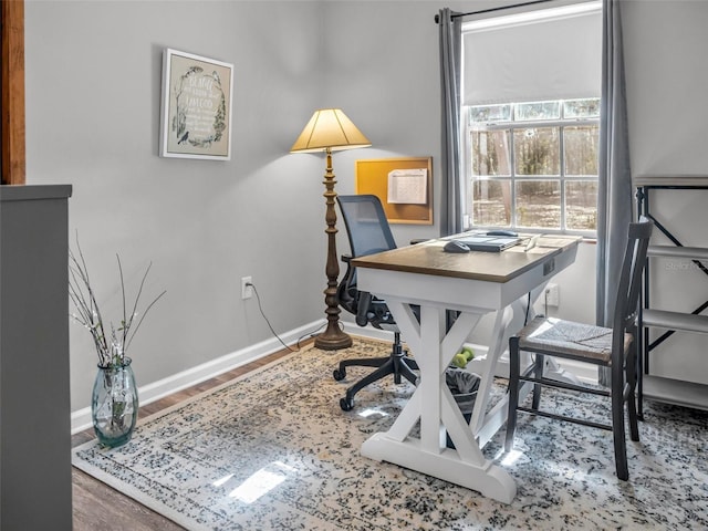 office area with baseboards and wood finished floors