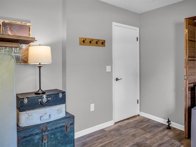 interior space with baseboards and wood finished floors