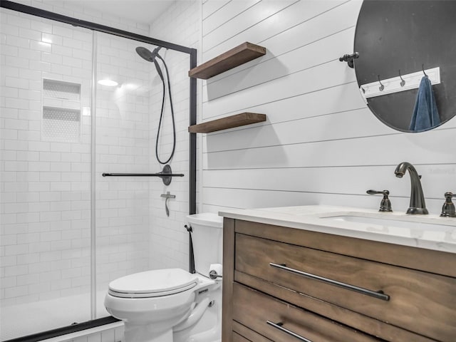 full bath with a stall shower, vanity, and toilet