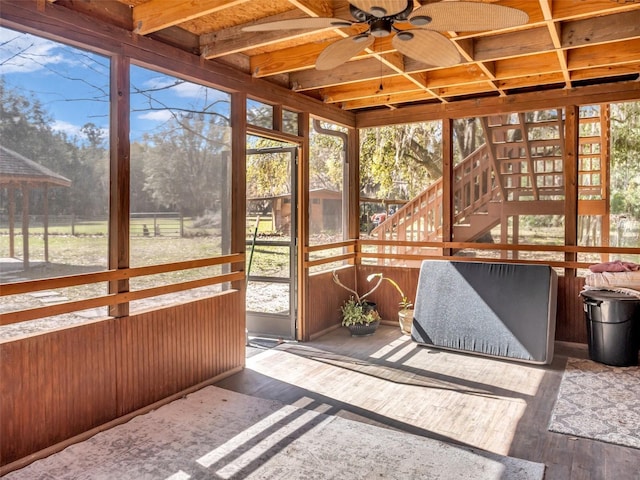 unfurnished sunroom with plenty of natural light and ceiling fan