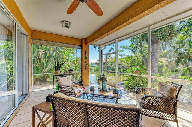 sunroom featuring a ceiling fan