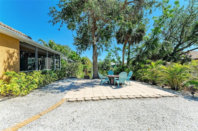 view of patio / terrace with a sunroom