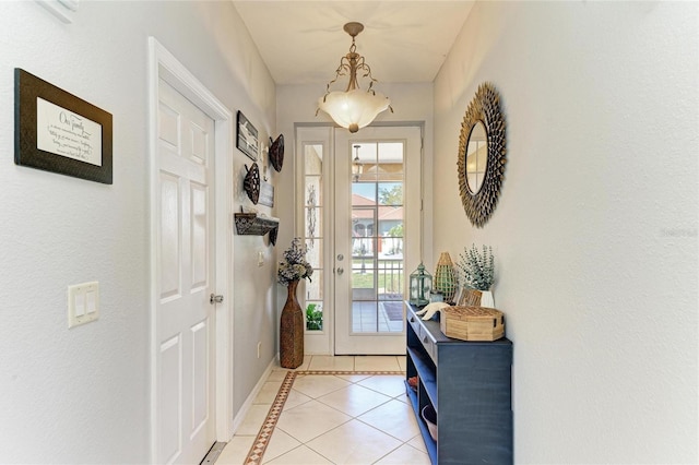 entryway featuring baseboards and light tile patterned floors