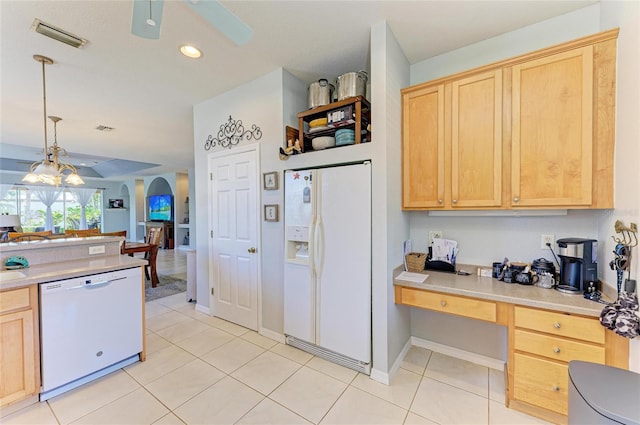 kitchen featuring white appliances, visible vents, arched walkways, light brown cabinets, and built in desk