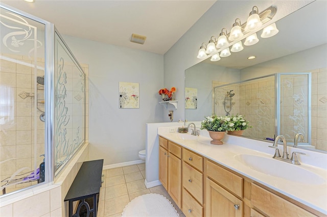 full bath with double vanity, a stall shower, tile patterned flooring, and a sink