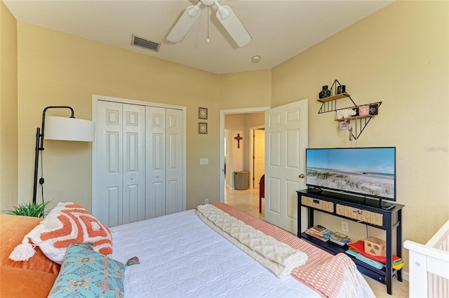 carpeted bedroom featuring a ceiling fan, visible vents, and a closet