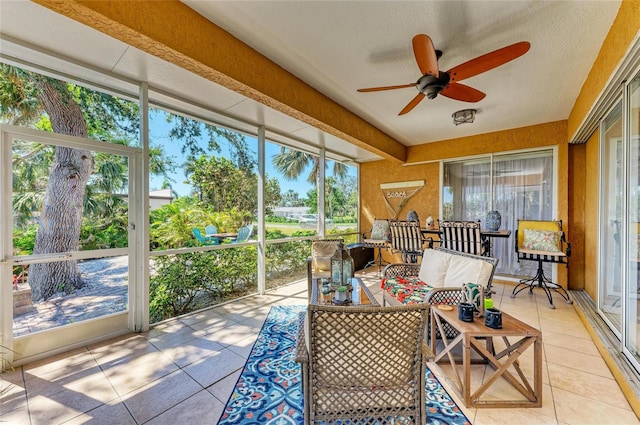 sunroom / solarium featuring ceiling fan