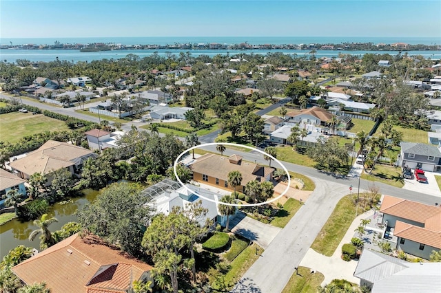 drone / aerial view with a water view and a residential view