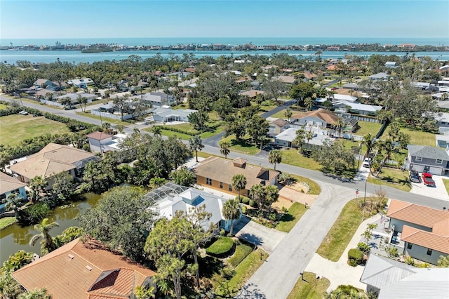 birds eye view of property featuring a water view and a residential view