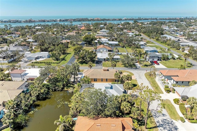 bird's eye view featuring a water view and a residential view