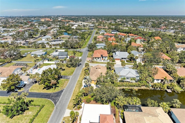 drone / aerial view with a residential view and a water view