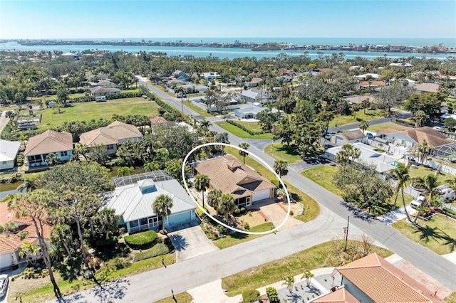 drone / aerial view with a residential view and a water view