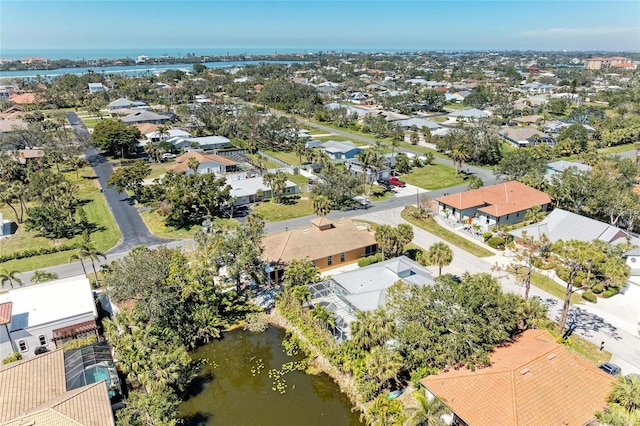 drone / aerial view featuring a water view and a residential view