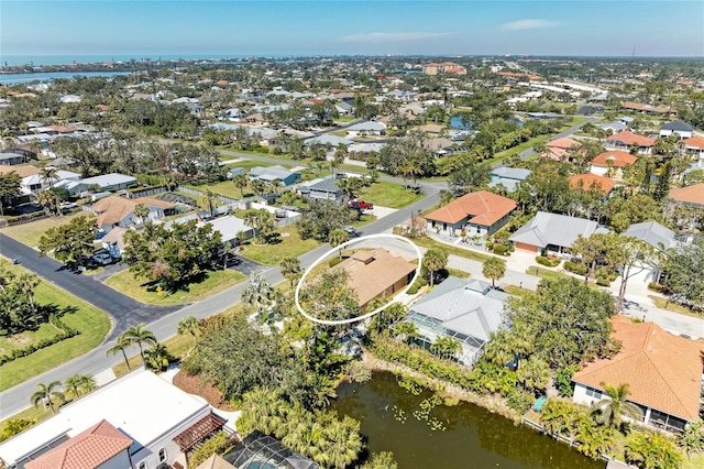 birds eye view of property featuring a water view and a residential view