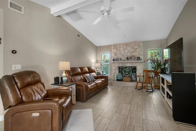 living room with visible vents, vaulted ceiling with beams, and a stone fireplace