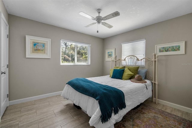 bedroom with wood finished floors, baseboards, and ceiling fan