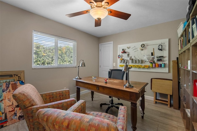 office space featuring baseboards and ceiling fan