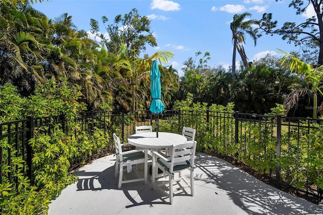 view of patio / terrace featuring outdoor dining space and fence