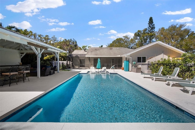 view of swimming pool with a patio area, a fenced in pool, a sunroom, and fence