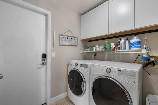 washroom featuring separate washer and dryer, baseboards, and cabinet space