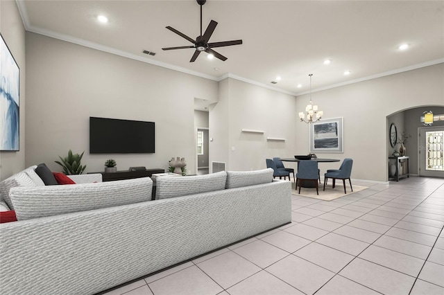 living area with visible vents, ornamental molding, recessed lighting, arched walkways, and light tile patterned floors