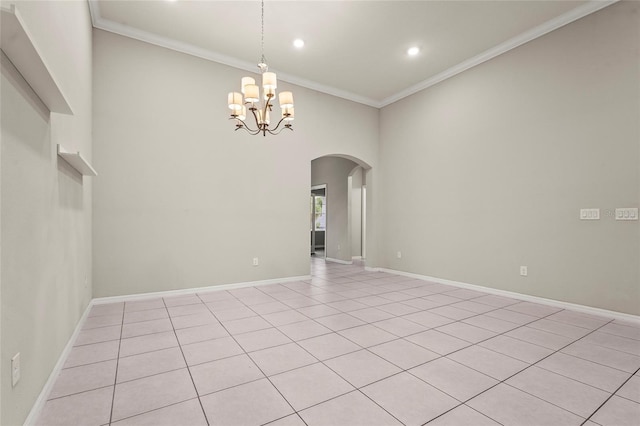 spare room with a chandelier, baseboards, arched walkways, ornamental molding, and recessed lighting