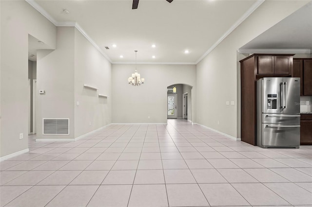 unfurnished living room featuring light tile patterned floors, ceiling fan with notable chandelier, baseboards, arched walkways, and visible vents