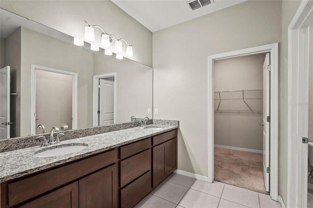 bathroom with visible vents, toilet, tile patterned flooring, and a sink