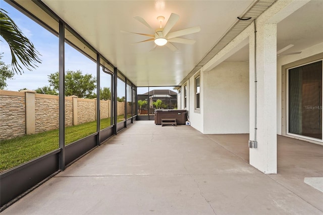 unfurnished sunroom with a ceiling fan